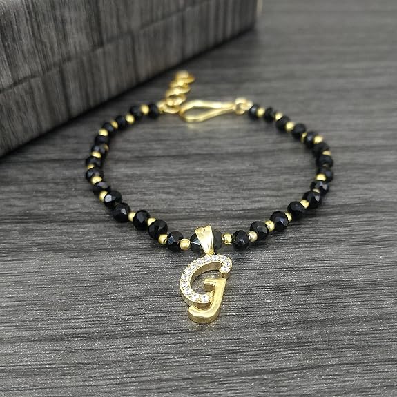 JEWELOPIA American diamond Alphabet gold plated CZ Studded Bracelet with Black beads for Women and Girls